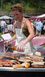 Christine Harbauer bastes sausages with beer, Cooperstown NY, photo by Lucy Saunders