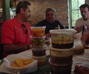 Hentry Alvarado (in red shirt) notes that some of the sauces will really "put the hurt on you"